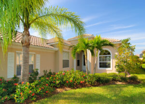 A beautiful Florida home with palm trees out front.